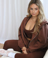 Woman lounging in Oversized Zip Hoodie in Hot Chocolate