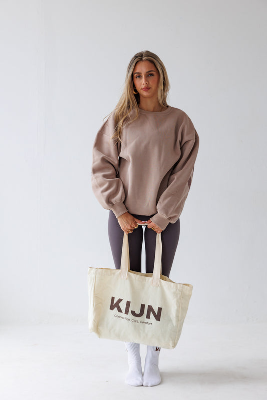 Minimalist neutral canvas tote paired with oversized sweaters for leggings