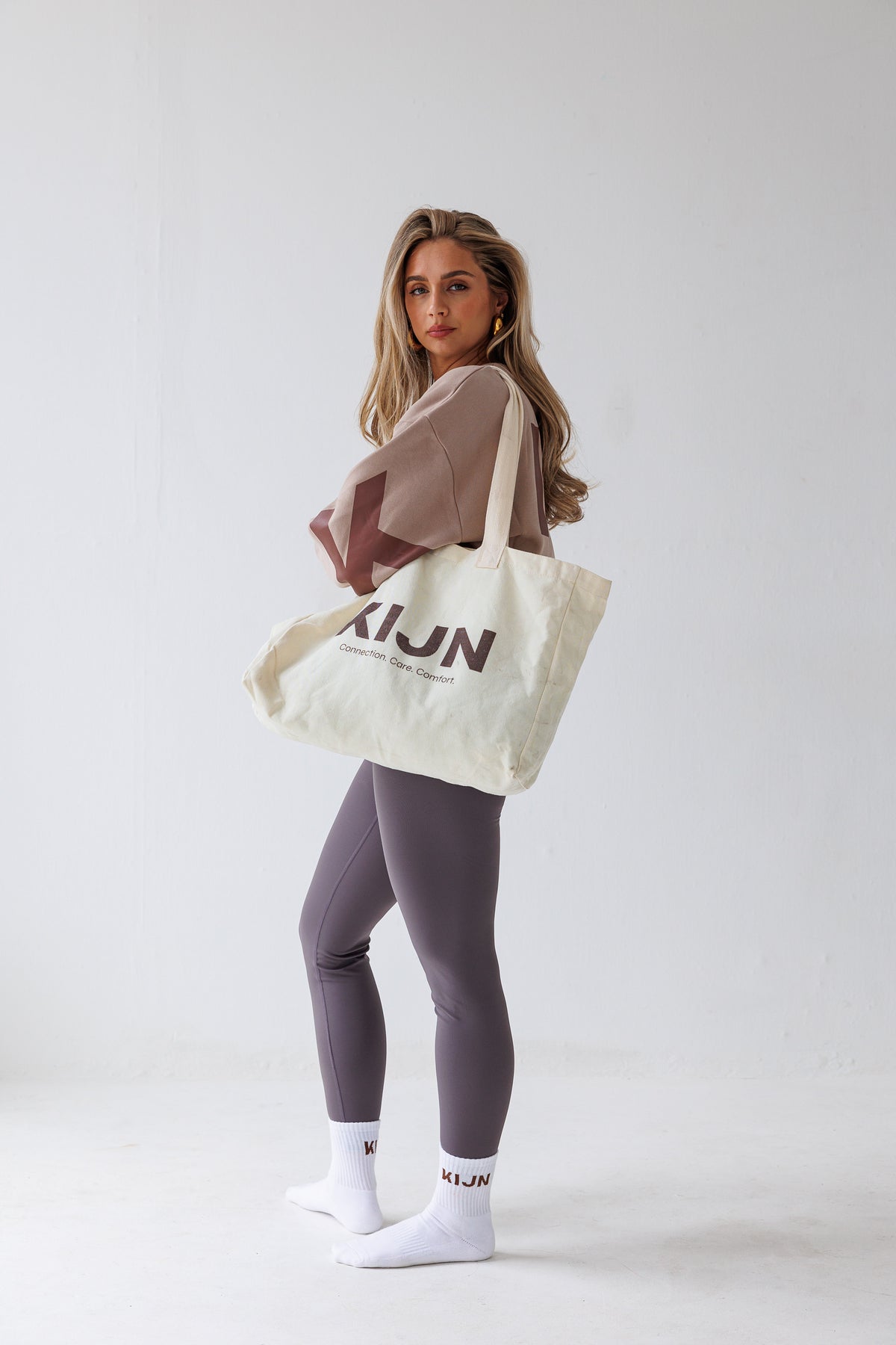 Oversized neutral tote worn with wrap waist leggings, KIJN accessories