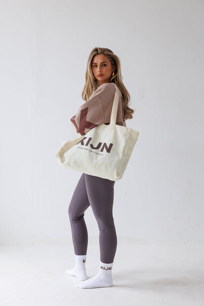 Oversized neutral tote worn with wrap waist leggings, KIJN accessories