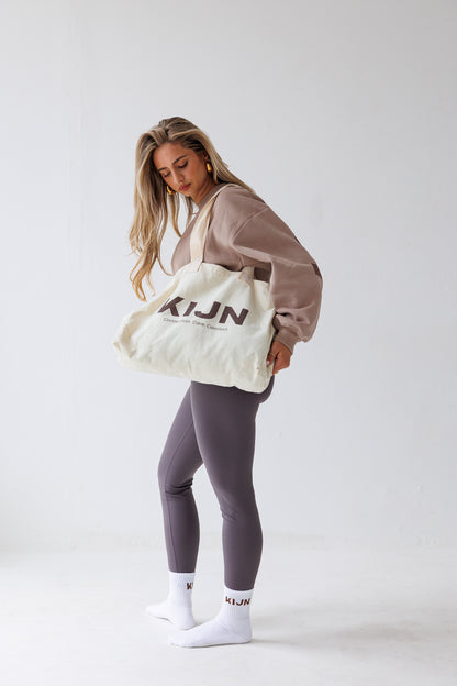 Unaltered neutral tote bag paired with coffee leggings outfit